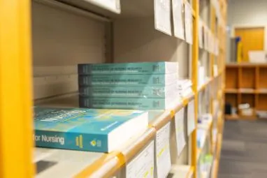 stacks of textbooks on store shelf